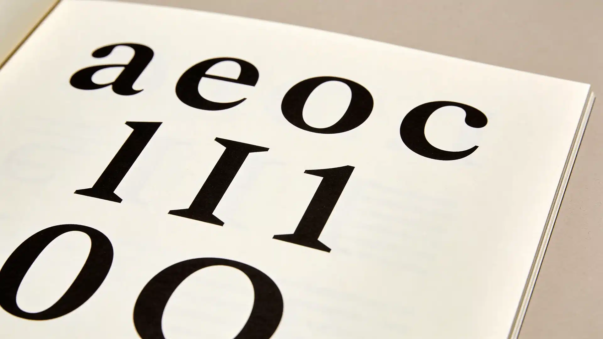 Printed page with enlarged letters and numbers arranged in rows for character comparison