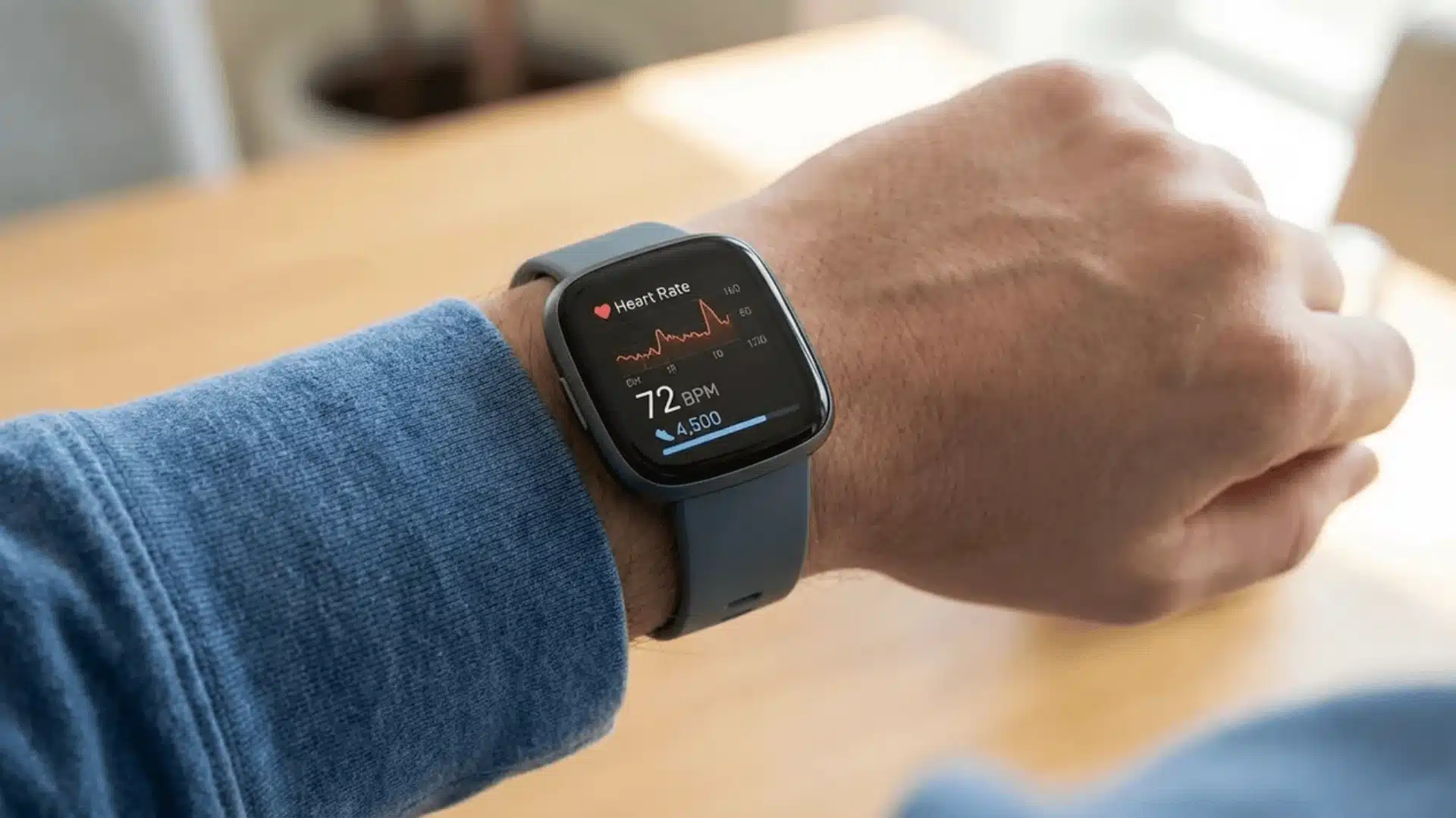 Close-up of smartwatch displaying heart rate and health data