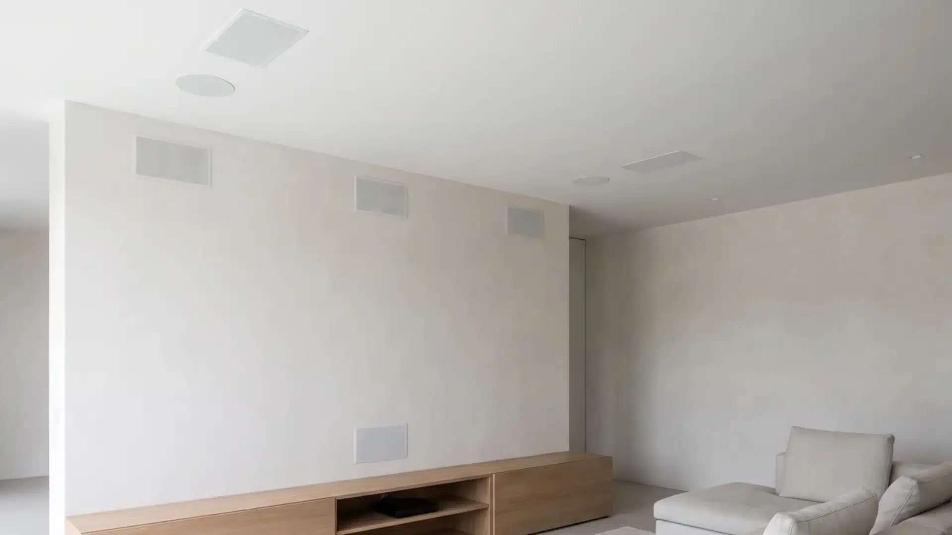 flush mounted speaker grilles integrated into wall and ceiling surfaces