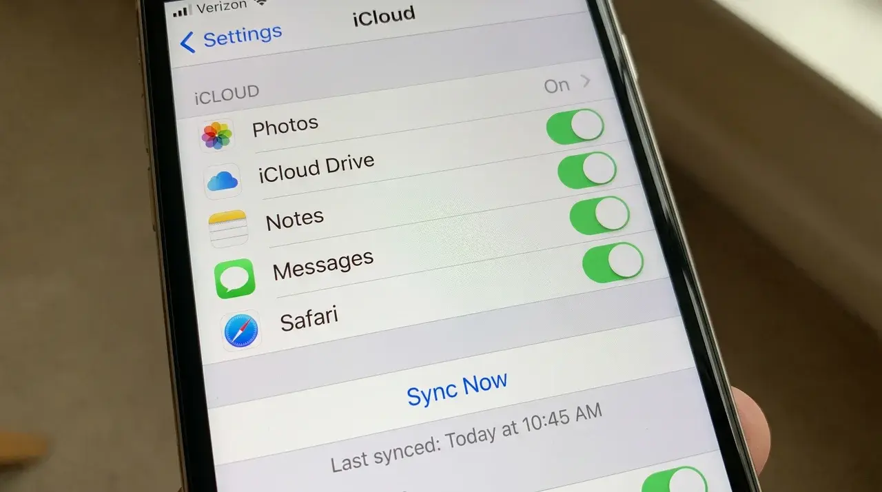 iPhone screen open to iCloud settings showing app list with Sync Now option