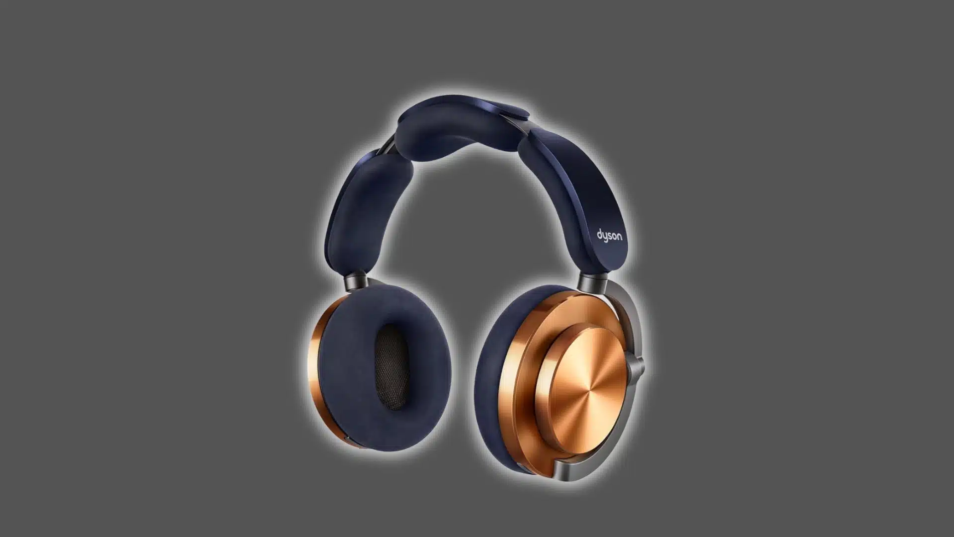 Dyson OnTrac headphones with gold ear cups and navy cushions on a dark studio background.
