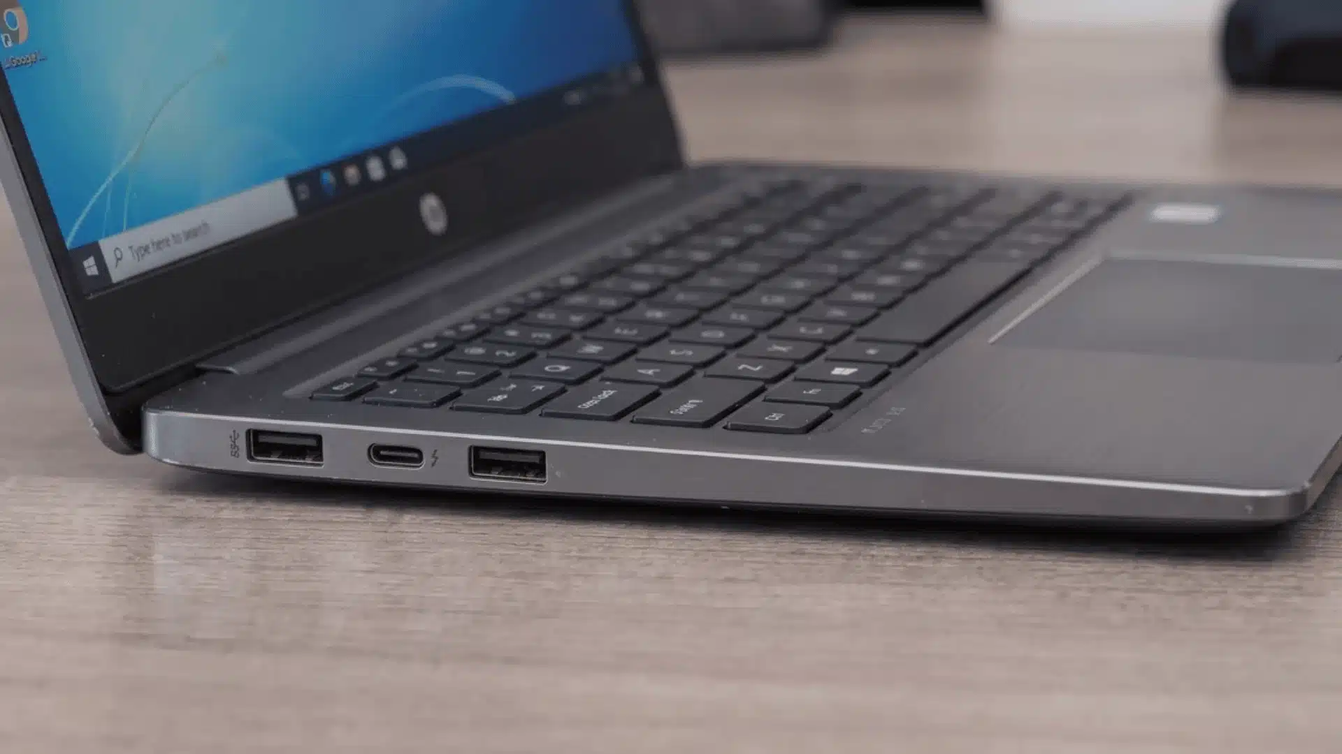 Open laptop with USB-A and USB-C ports marked SS and a lightning bolt