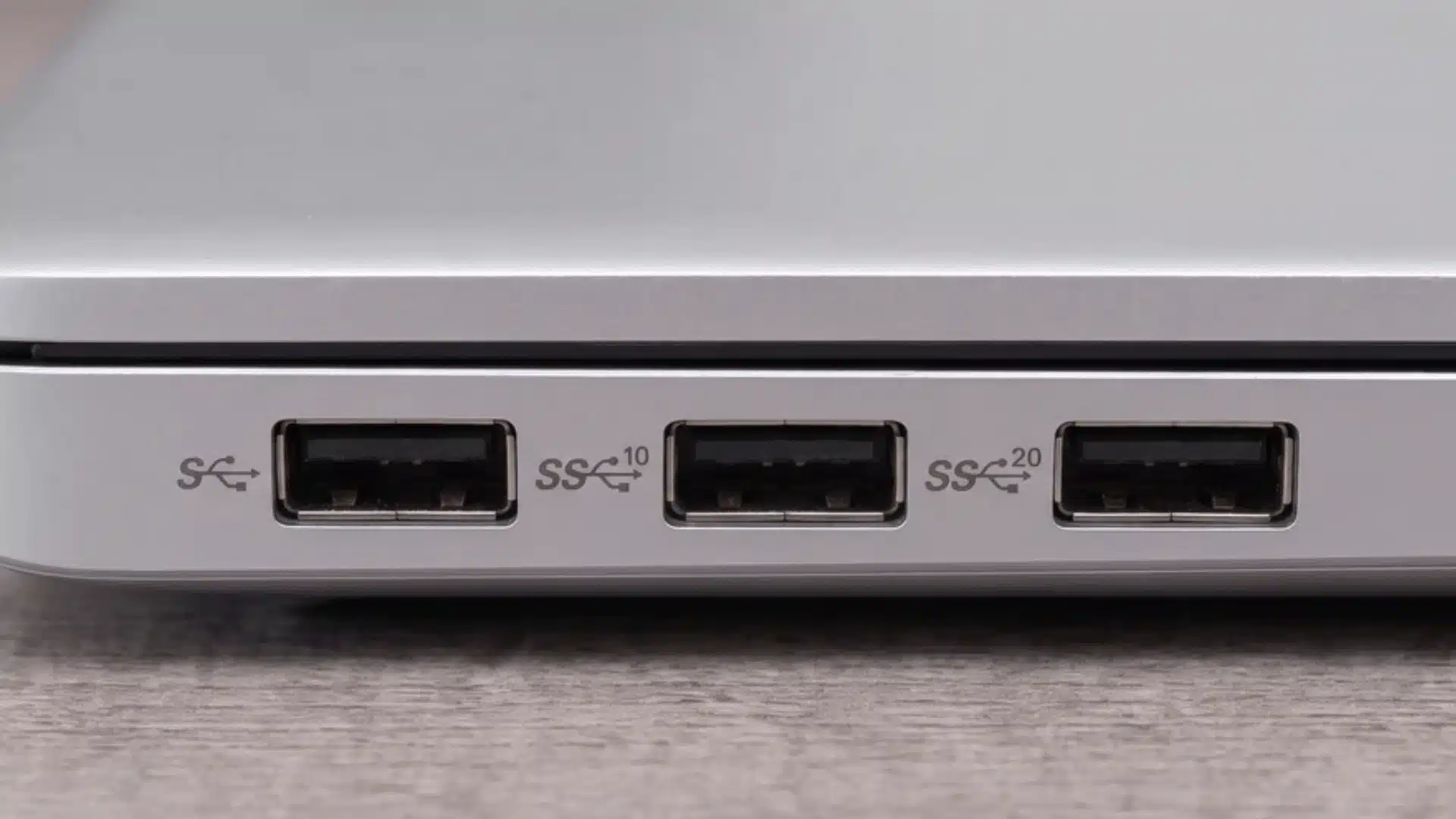 Three USB-A ports labeled SS, SS 10, and SS 20 on a laptop edge