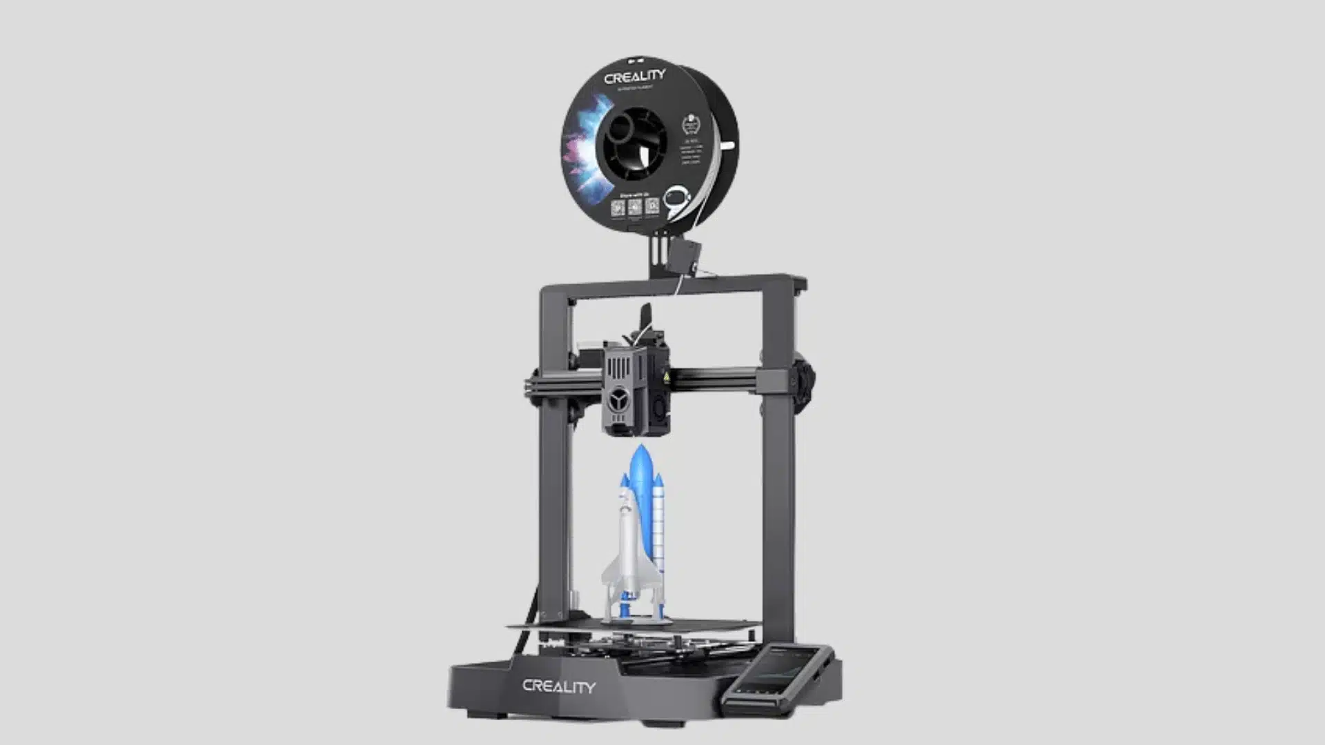 Creality Ender-3 V3 KE 3D printer with top-mounted filament spool, touchscreen, and rocket model on the print bed