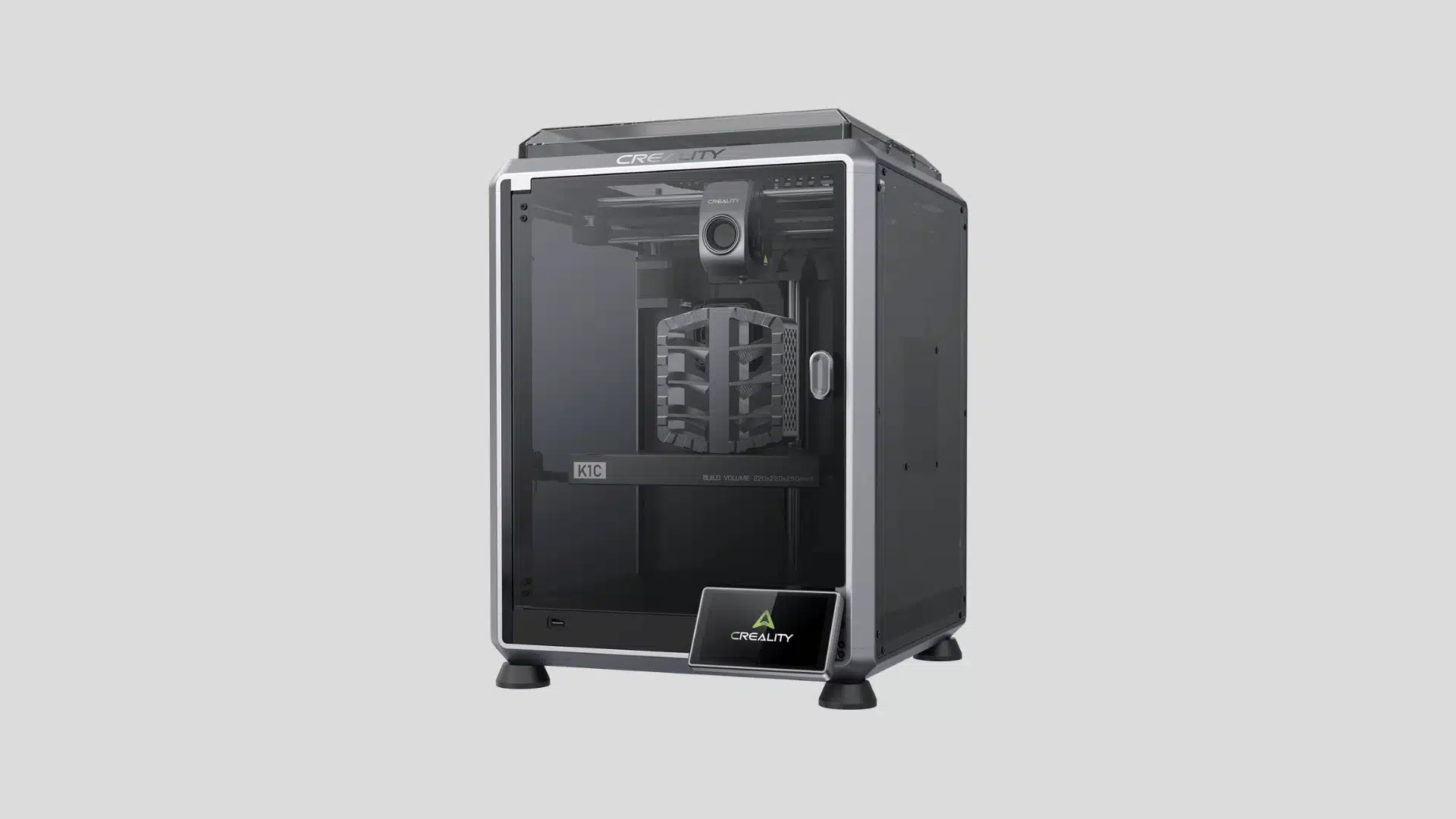 Creality K1C enclosed 3D printer with a geometric model on the print bed and front touchscreen