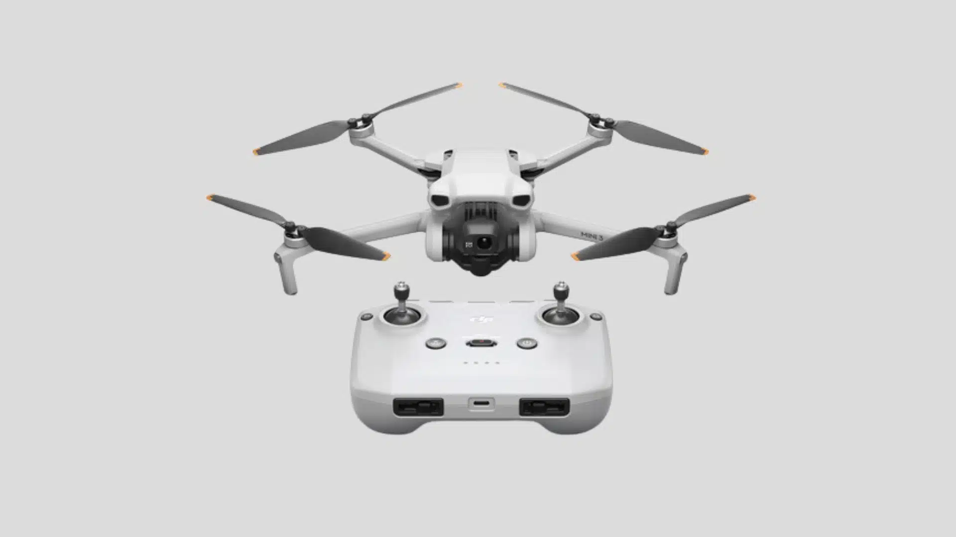 DJI Mini 3 camera drone with four propellers, front-mounted gimbal camera, and remote controller