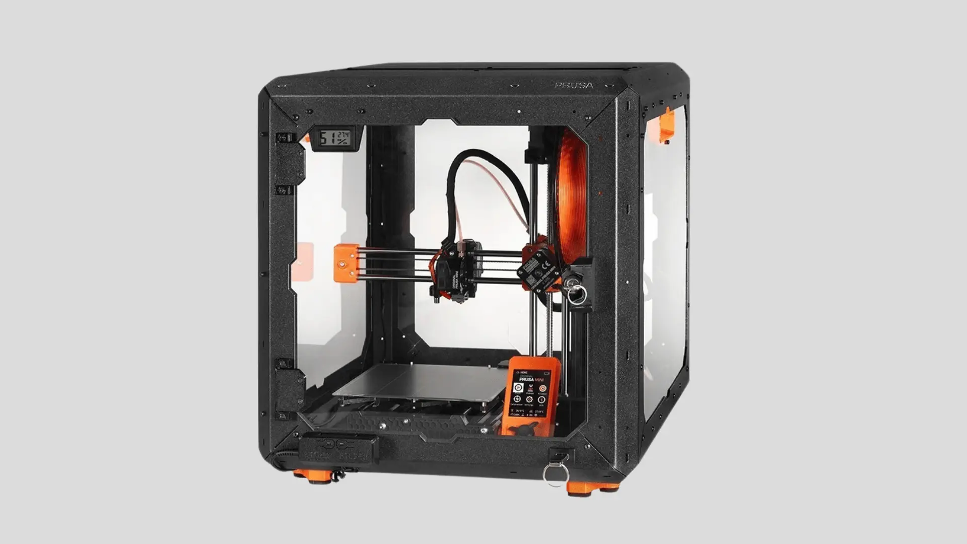 Prusa MINI+ 3D printer inside a black enclosure with orange accents, print bed, extruder, and control screen