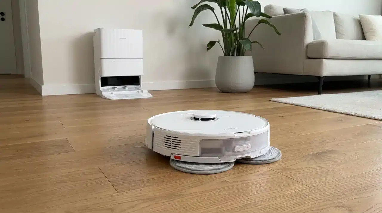 Roller robot mop passing through a fresh liquid spill on a hard kitchen floor