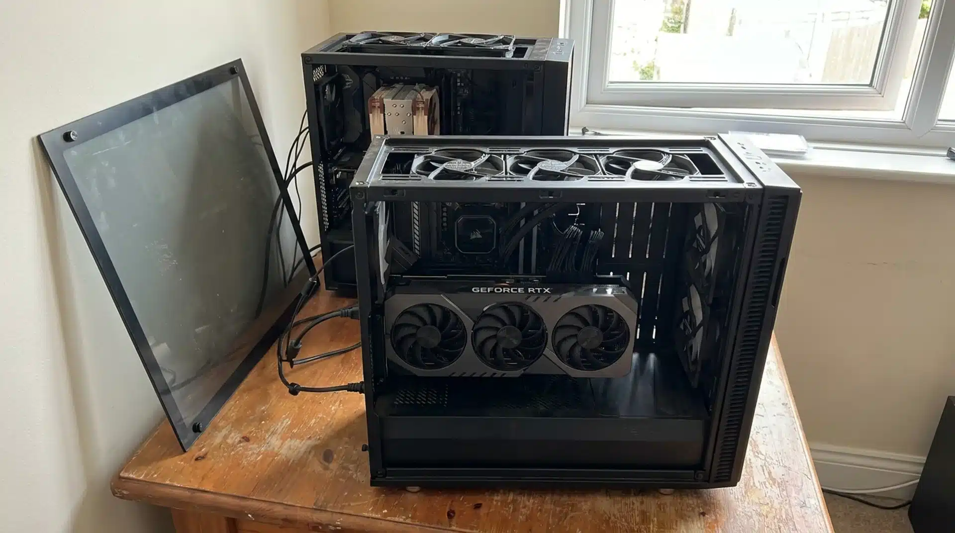 Two real gaming PCs with different GPU cooling setups and airflow.