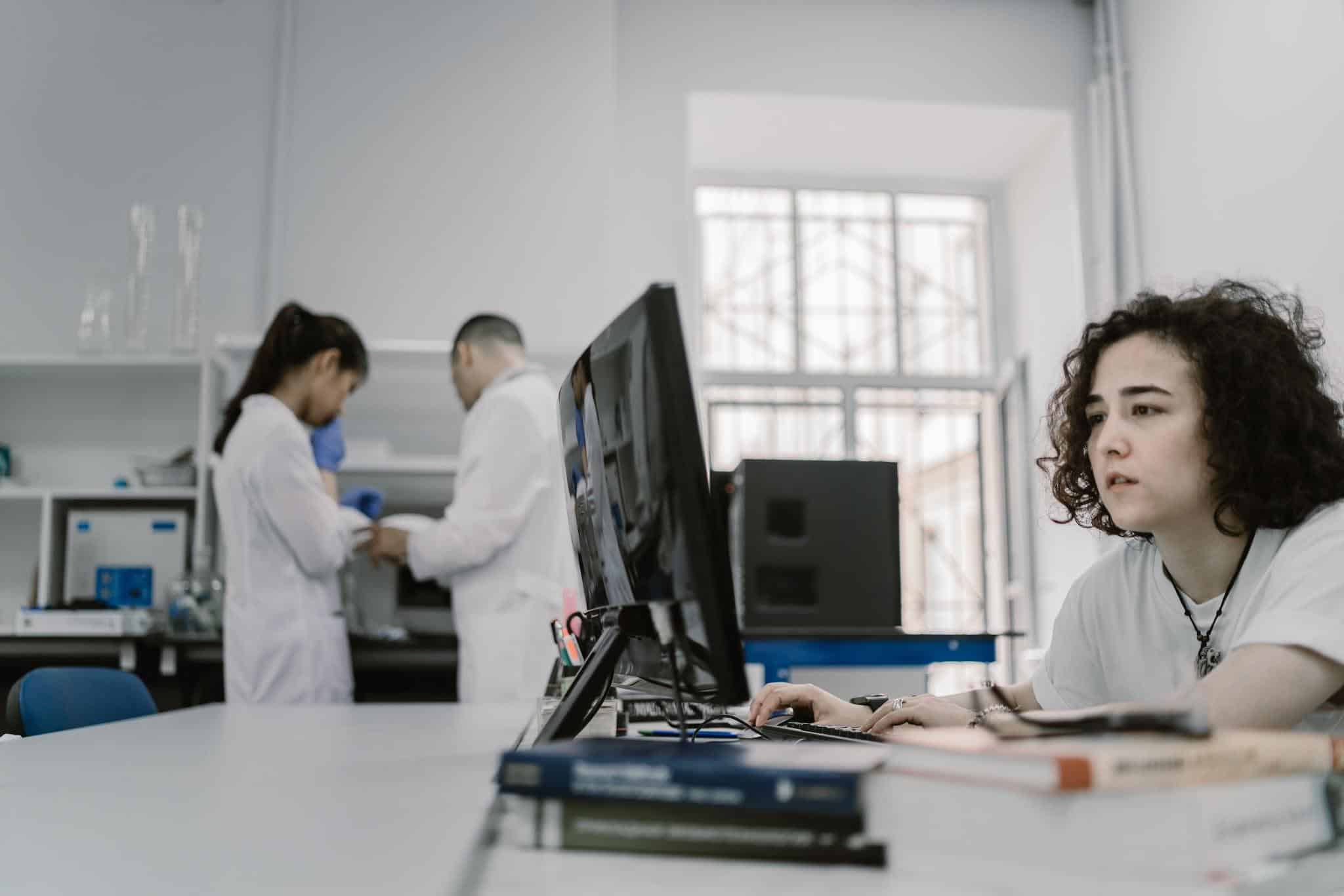 Researcher working on computer in laboratory.