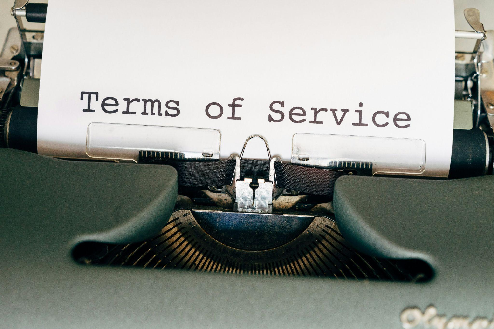 Typewriter with paper showing "Terms of Service" in vintage setting