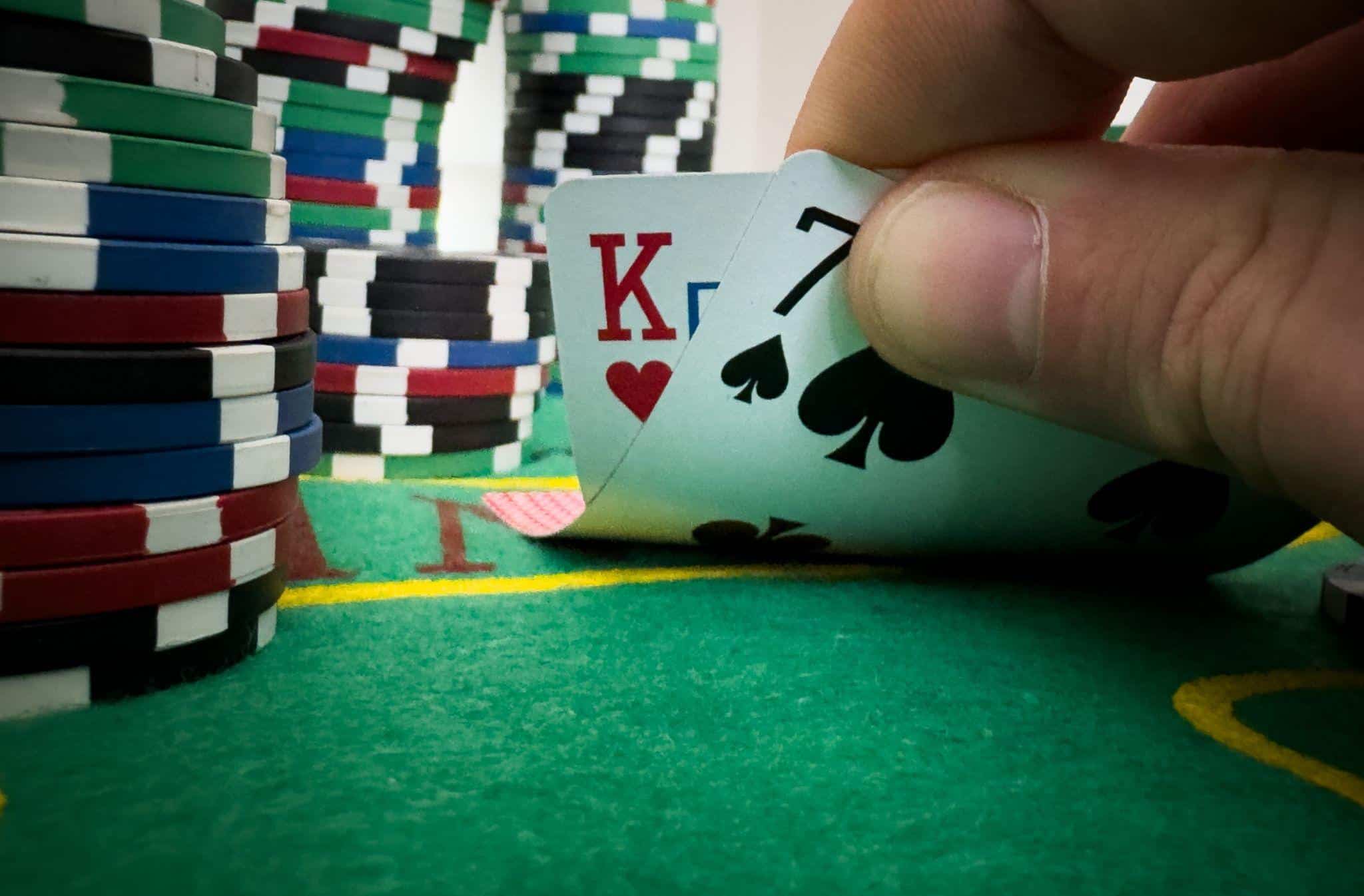 Two cards and a set of poker coins kept on a table